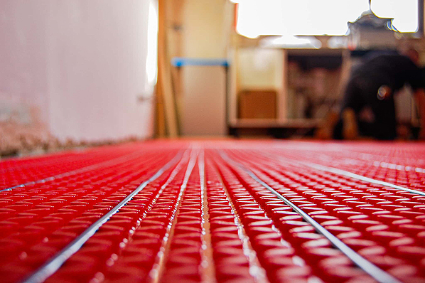 Warmup wet hydronic underfloor heating pipes and manifold system.
